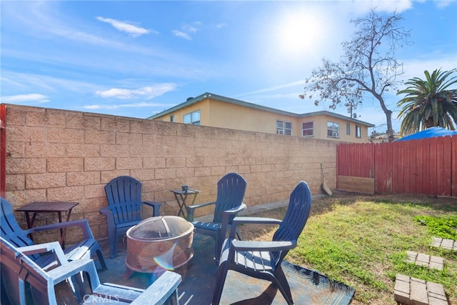 view of patio / terrace with a fenced backyard and a fire pit