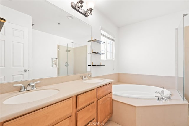 bathroom with double vanity, a stall shower, a garden tub, and a sink