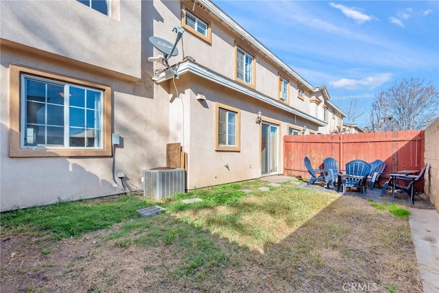 view of yard featuring a fire pit, cooling unit, and fence