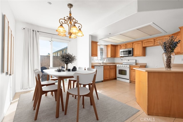 dining area with light tile patterned floors and a chandelier