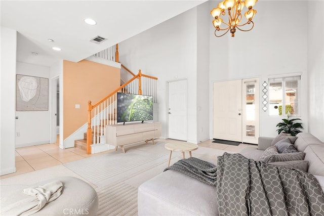 tiled living area featuring recessed lighting, visible vents, stairway, a towering ceiling, and a chandelier