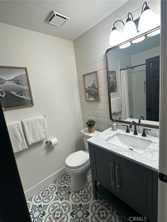 37211 Jerome Ln, Murrieta, CA 92562 - full bathroom featuring vanity, toilet, a textured ceiling, wood walls, and baseboards
