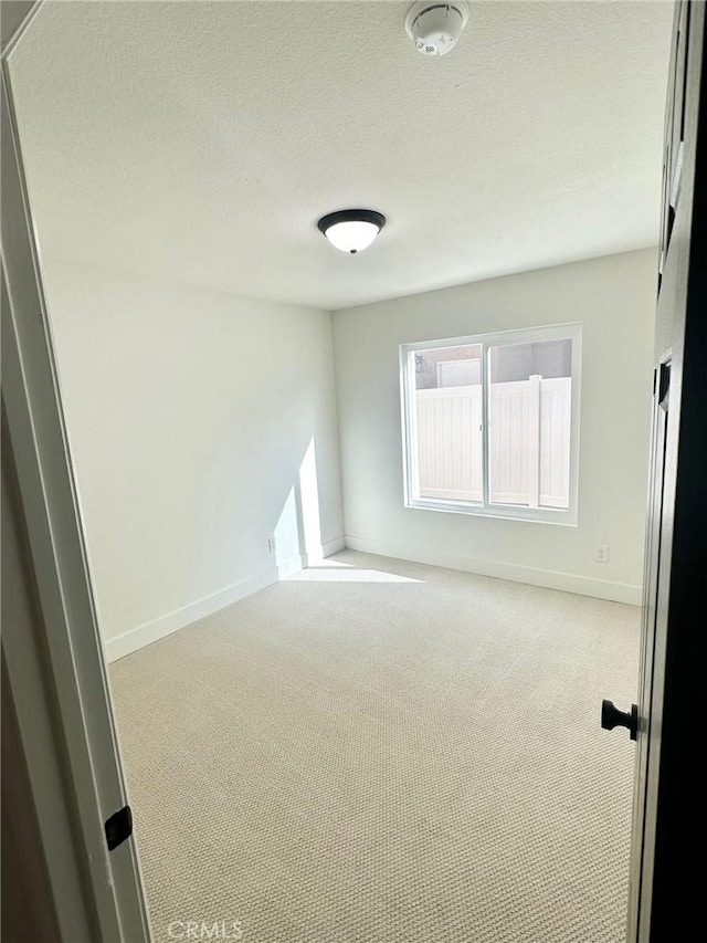 37211 Jerome Ln, Murrieta, CA 92562 - carpeted empty room with a smoke detector, baseboards, and a textured ceiling