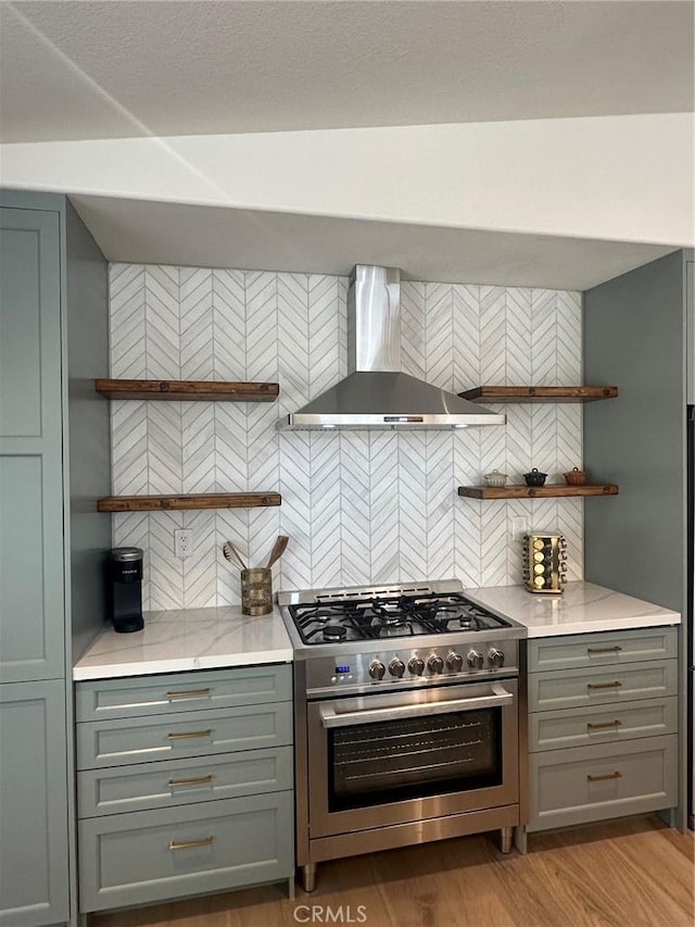 37211 Jerome Ln, Murrieta, CA 92562 - kitchen featuring open shelves, wall chimney exhaust hood, stainless steel stove, gray cabinets, and backsplash
