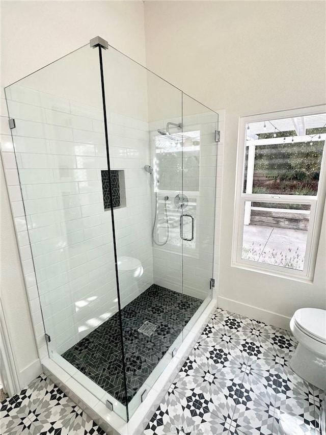 37211 Jerome Ln, Murrieta, CA 92562 - bathroom featuring baseboards, toilet, a stall shower, and tile patterned flooring