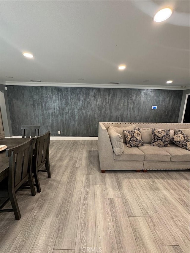 living area with recessed lighting, wood finished floors, and crown molding