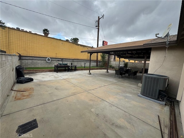 view of patio / terrace with central AC, outdoor dining area, and a fenced backyard