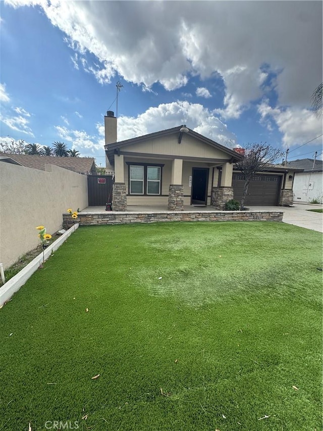 view of front of property with a chimney, fence, stone siding, driveway, and a front lawn