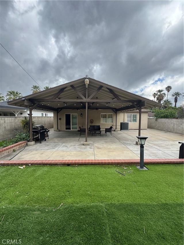 back of property with a patio area, fence, cooling unit, and a yard