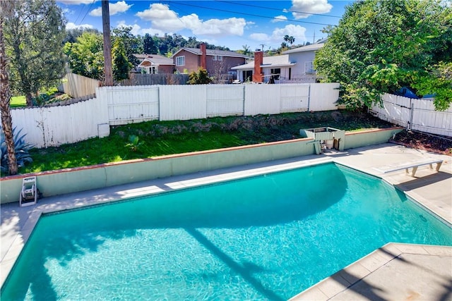 view of swimming pool featuring a fenced in pool, a patio area, and a fenced backyard