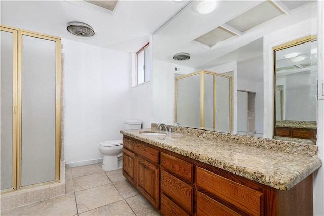 bathroom with a stall shower, vanity, toilet, and tile patterned floors