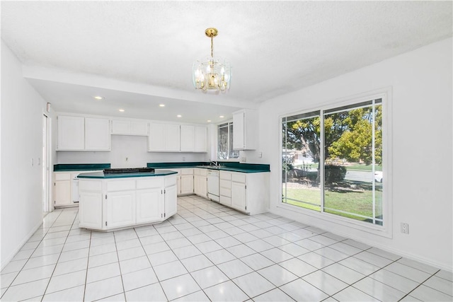 kitchen featuring a notable chandelier, light tile patterned floors, white cabinetry, a kitchen island, and white dishwasher