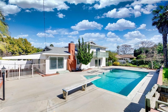 view of pool featuring a fenced in pool, a patio area, fence, and a diving board