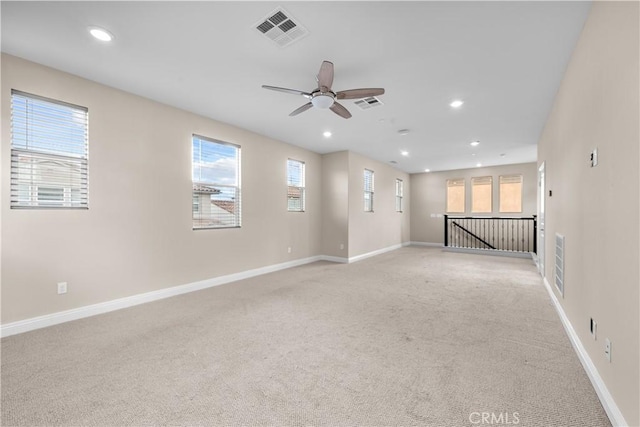 spare room with visible vents, recessed lighting, ceiling fan, and light colored carpet
