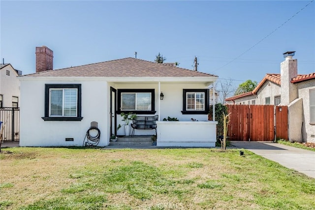 bungalow-style home featuring a chimney, crawl space, fence, a front lawn, and stucco siding