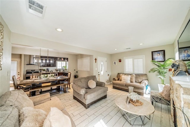 living area featuring visible vents and recessed lighting