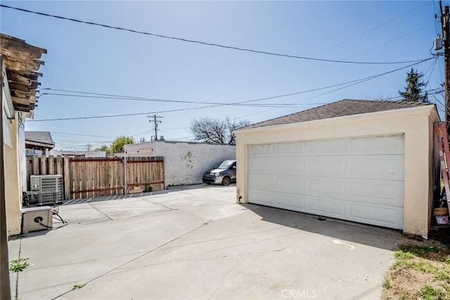 detached garage featuring fence