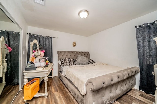 bedroom with wood finished floors and visible vents