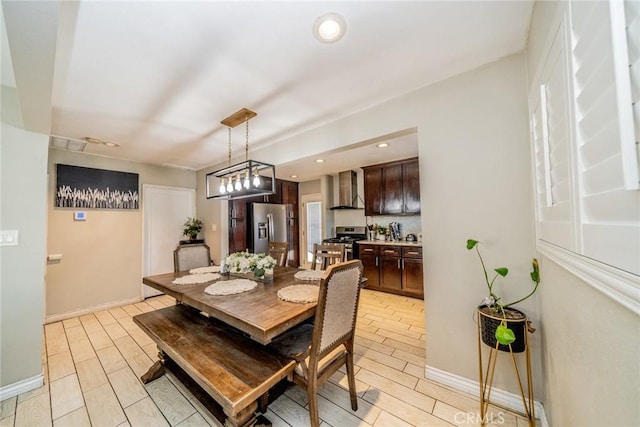 dining space featuring wood tiled floor, baseboards, and recessed lighting