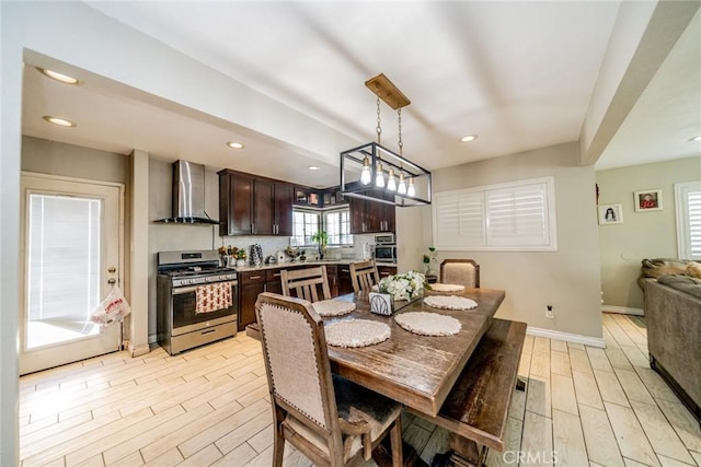 dining room featuring recessed lighting, a toaster, light wood-style flooring, and baseboards