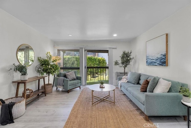 living room with recessed lighting and light wood-style flooring