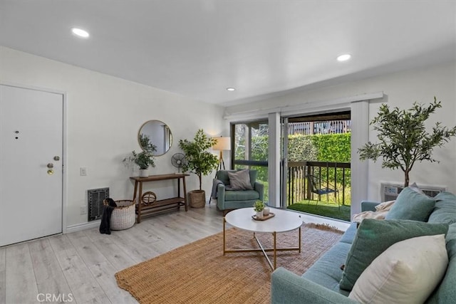 living room featuring recessed lighting, visible vents, and wood finished floors