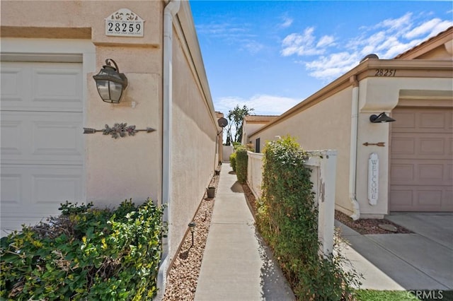 view of home's exterior with an attached garage and stucco siding