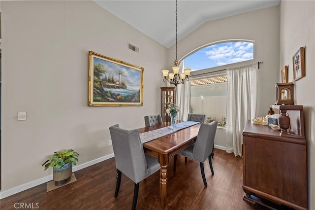 dining room featuring a chandelier, visible vents, vaulted ceiling, and wood finished floors