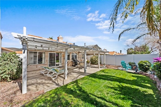 rear view of property with a patio area, a lawn, fence, and a pergola