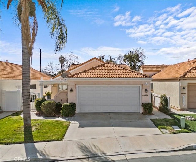 view of front of property with driveway, an attached garage, a tiled roof, and stucco siding