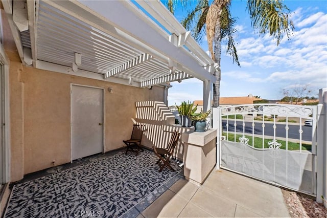 view of patio with a balcony and a pergola