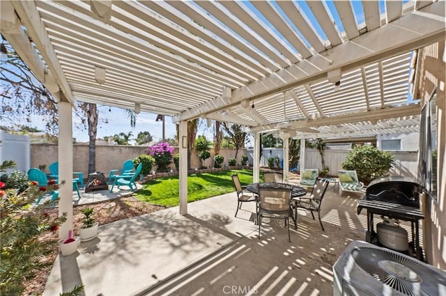 view of patio / terrace with an outdoor fire pit, outdoor dining area, a fenced backyard, and a pergola