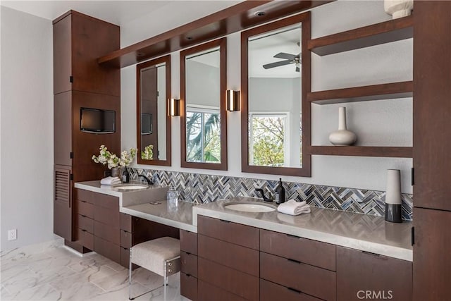 full bathroom with marble finish floor, double vanity, a sink, and decorative backsplash