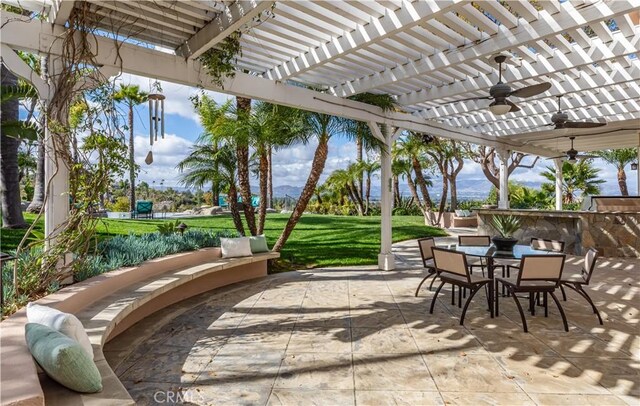 view of patio with a ceiling fan, outdoor dining area, and a pergola