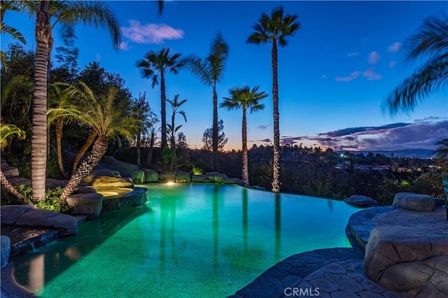 pool at dusk with an infinity pool