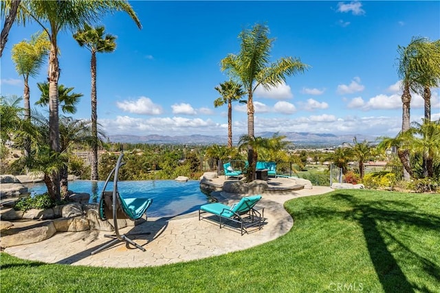 view of swimming pool featuring a patio area and a yard