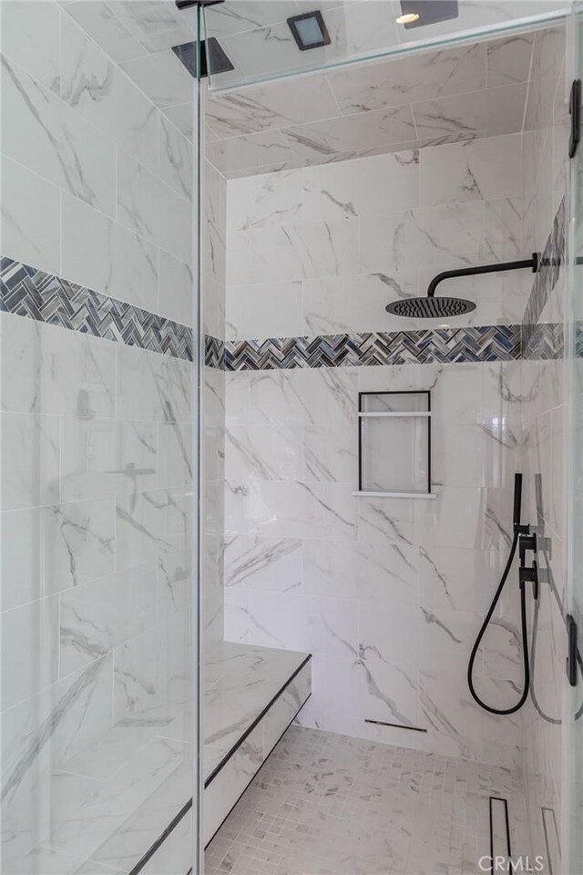 full bathroom with a marble finish shower