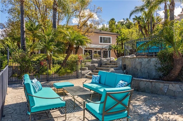 view of patio / terrace featuring fence, stairway, and an outdoor hangout area