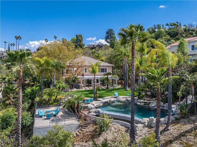 view of swimming pool featuring a lawn and a patio