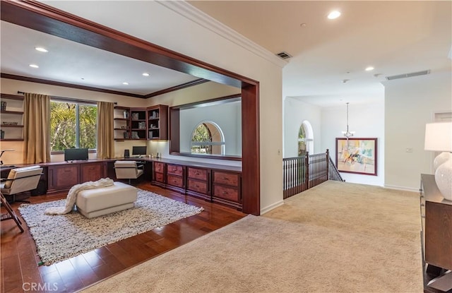 interior space with dark colored carpet, ornamental molding, visible vents, and recessed lighting