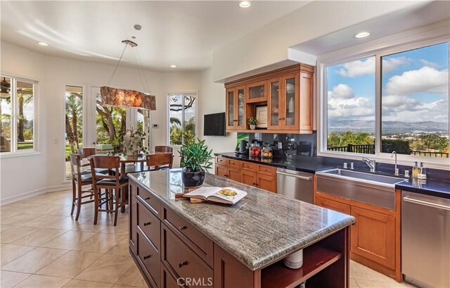 kitchen featuring a sink, brown cabinetry, open shelves, and dishwasher