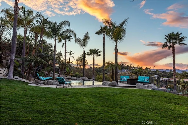 view of home's community with an outdoor hangout area, a lawn, and a patio