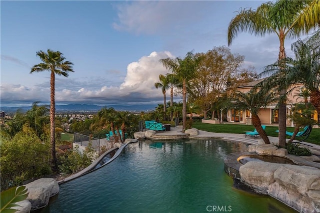 outdoor pool with a patio area and fence