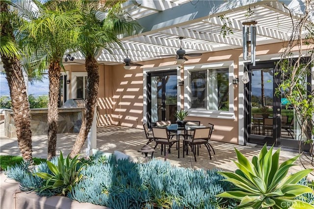 view of patio / terrace featuring ceiling fan, a pergola, and outdoor dining space