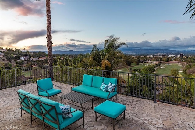 patio terrace at dusk with a mountain view and an outdoor hangout area