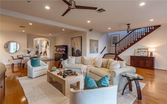 living area featuring a ceiling fan, recessed lighting, visible vents, and light wood-style floors