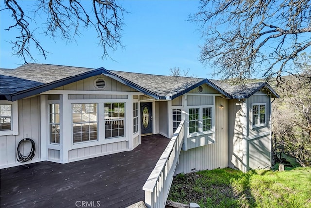 view of front of home featuring crawl space, a shingled roof, and a deck