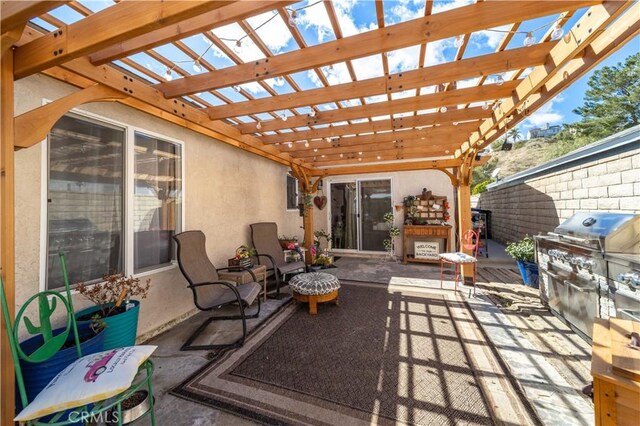 view of patio featuring grilling area and a pergola