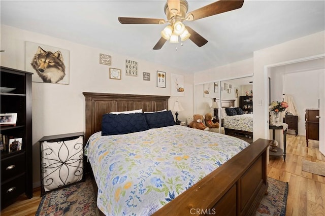 bedroom with light wood-type flooring and a ceiling fan