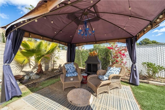 view of patio / terrace with fence and a gazebo